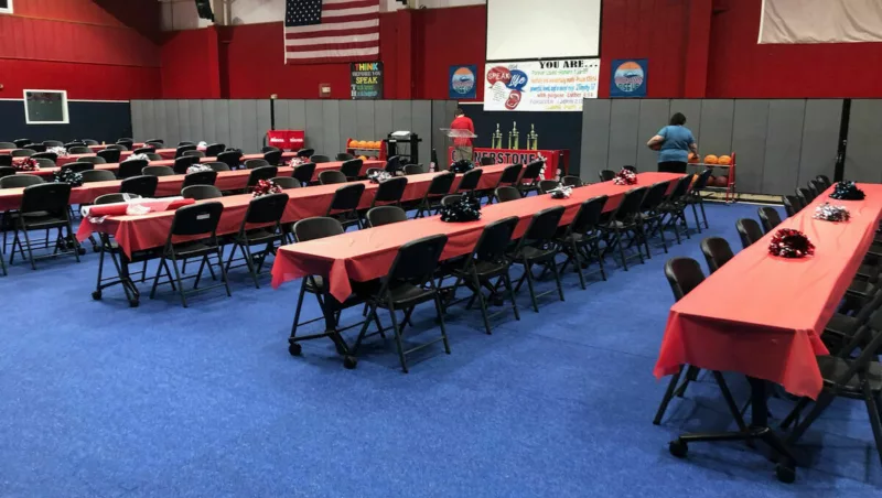 Gym carpet tiles protecting hardwood during a school banquet event