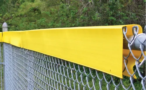 Yellow Safety Top Cap molded cap installed along the top of an outfield chain-link fence