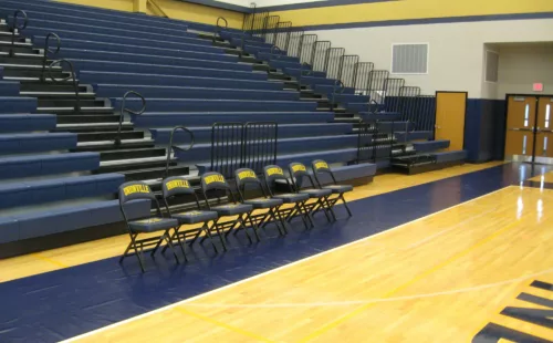 Custom courtside runner in navy blue vinyl protecting basketball court hardwood from high-traffic wear