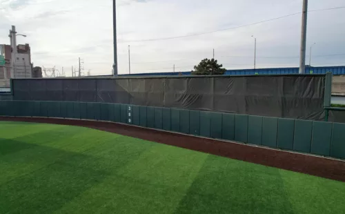 FenceMate baseball batter's eye screen with green outfield wall padding installed at University of Pennsylvania baseball field